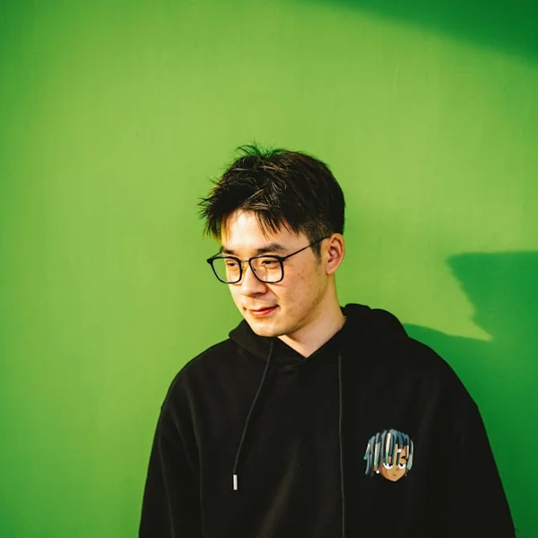 Guest portrait against a green background